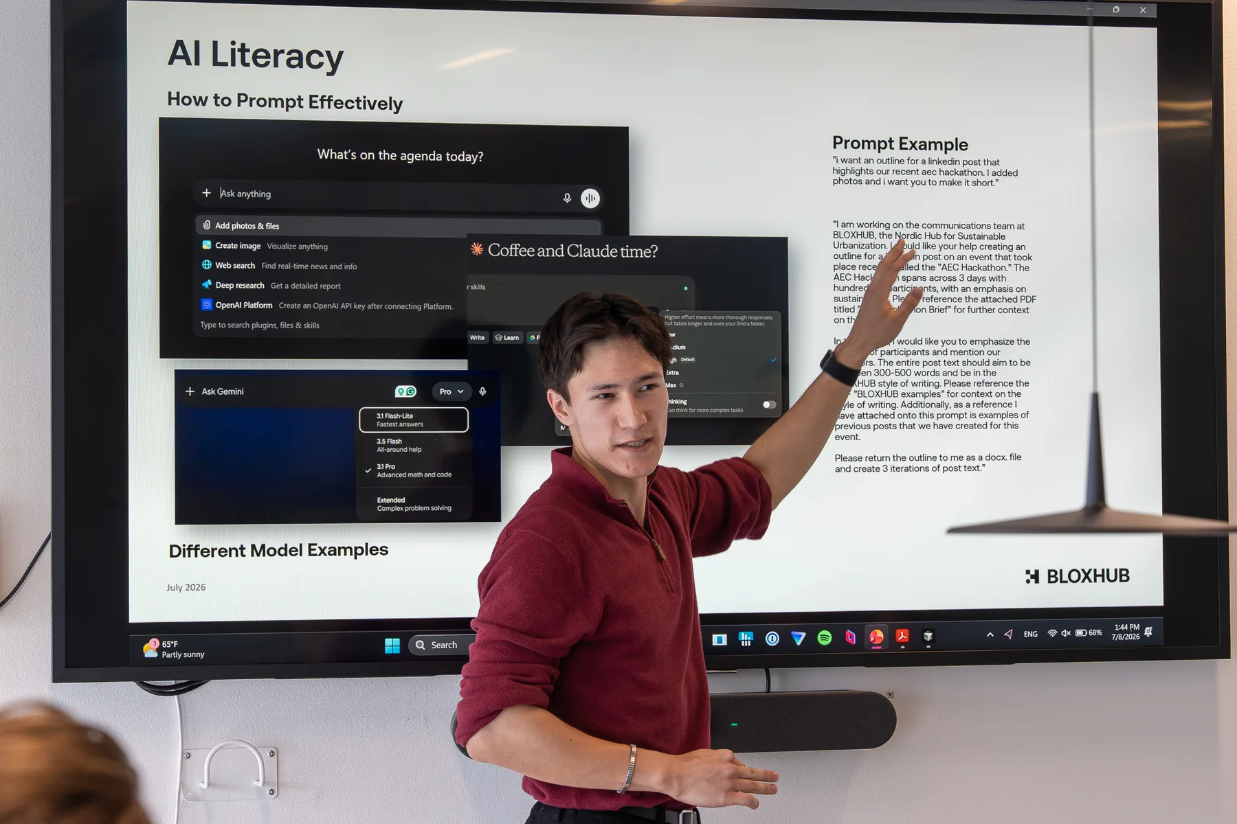 Presenting the AI literacy session to the BLOXHUB team, with the prompt-example slide on screen comparing a one-line request against a fully specified one